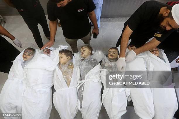 graphic-content-family-members-and-hospital-staff-stand-around-the-bodies-of-seven-children-2311460222.jpg